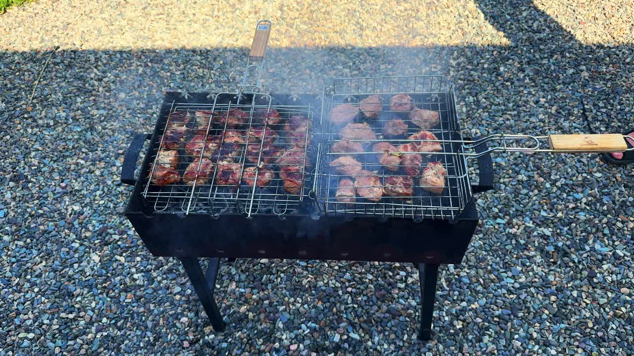 A Summer Barbecue Featuring Delicious Grilled Meats on a Charcoal Grill Surrounded by a Cozy Outdoor Setting, Perfect for Family Gatherings and Parties