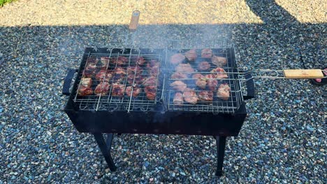 a summer barbecue featuring delicious grilled meats on a charcoal grill surrounded by a cozy outdoor setting, perfect for family gatherings and parties