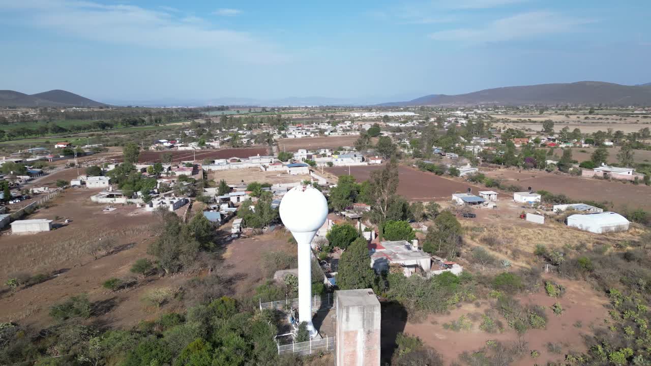 Water tank full of water in the middle of a town. Urban area. Drone shot.