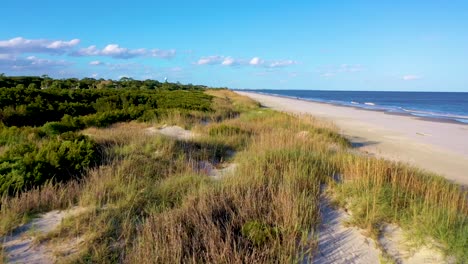 a spectacular speeding drone shot of the dunes of jekyll island