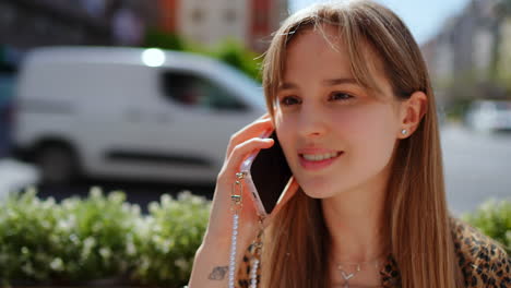 young woman talking on phone outdoors