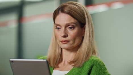 Pensive-businesswoman-watching-pad-in-office-portrait.-Woman-working-computer