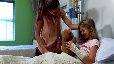 mother giving teddy bear to her daughter 4k