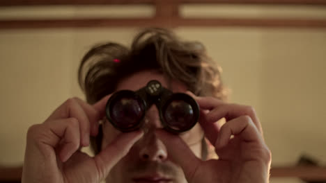 person observing with binoculars