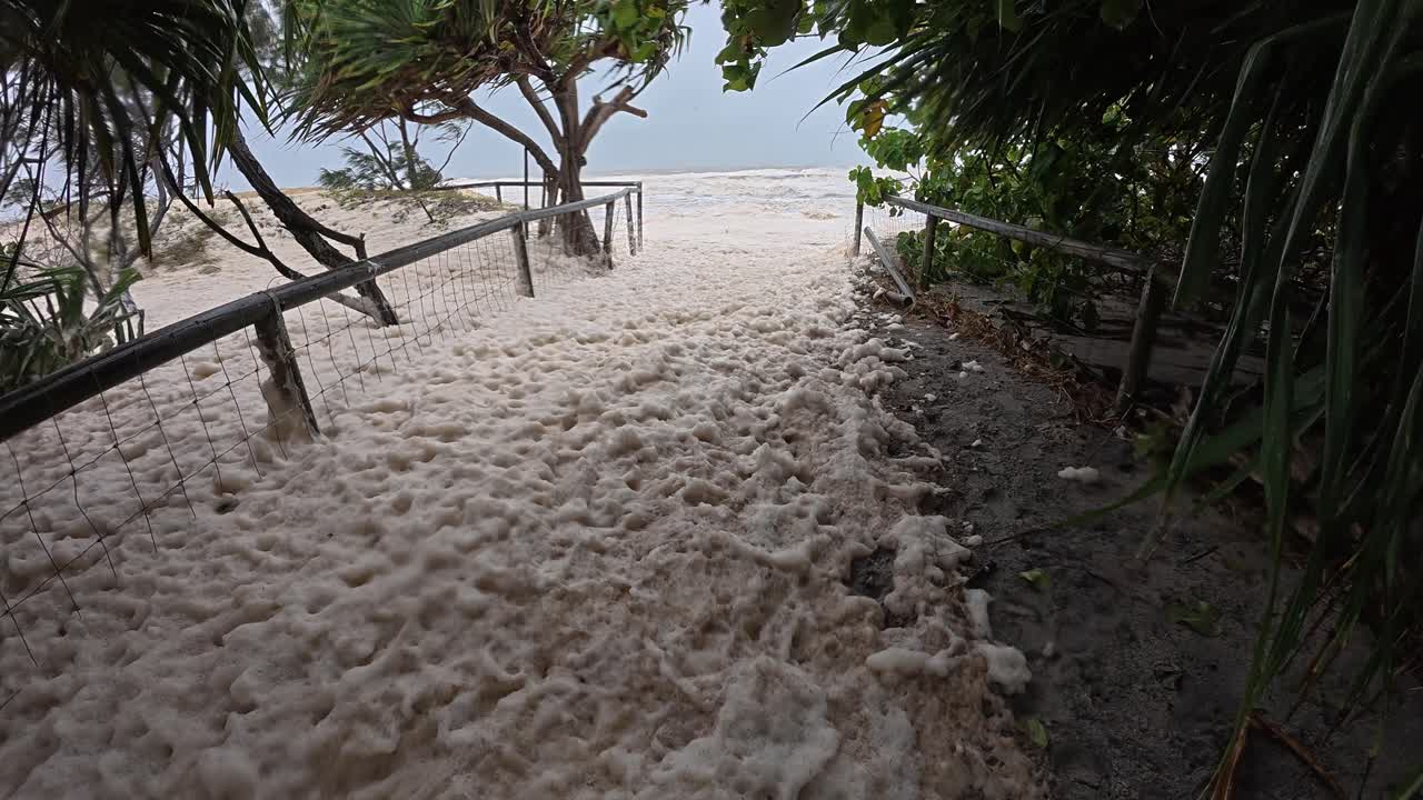 Path Going To The Beach Covered With Sea Foam During Cyclone Alfred In Australia. - POV shot