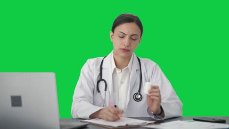 Indian-female-doctor-giving-medicine-to-patient-Green-screen