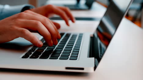 person typing on a laptop