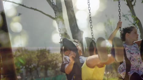 children on swings and sunlit trees