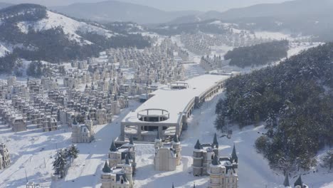 aerial shot of abandoned mall covered in snow at burj al babas property development