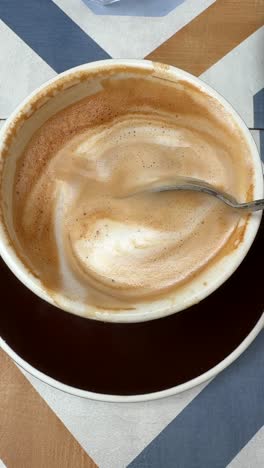 latte in a cup with a spoon