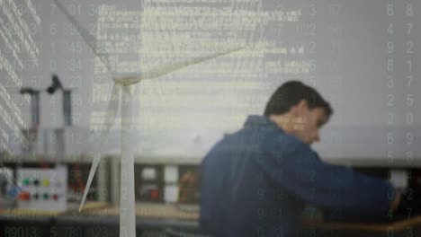 screen with data processing against caucasian male worker working with windmill