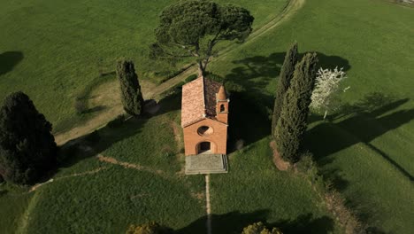 ancient stone church on green meadow with vegetation