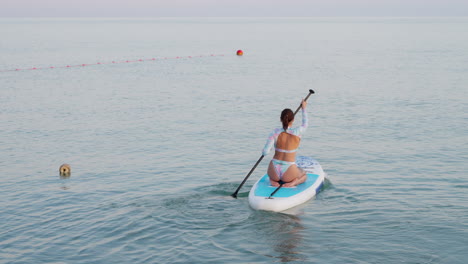 woman paddleboarding in the ocean