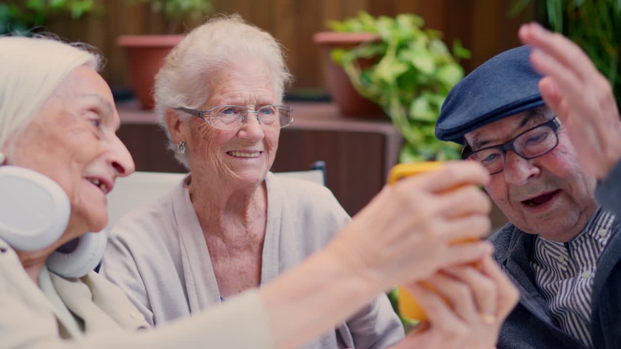 Group of Elderly Friends Using a Mobile Phone Together