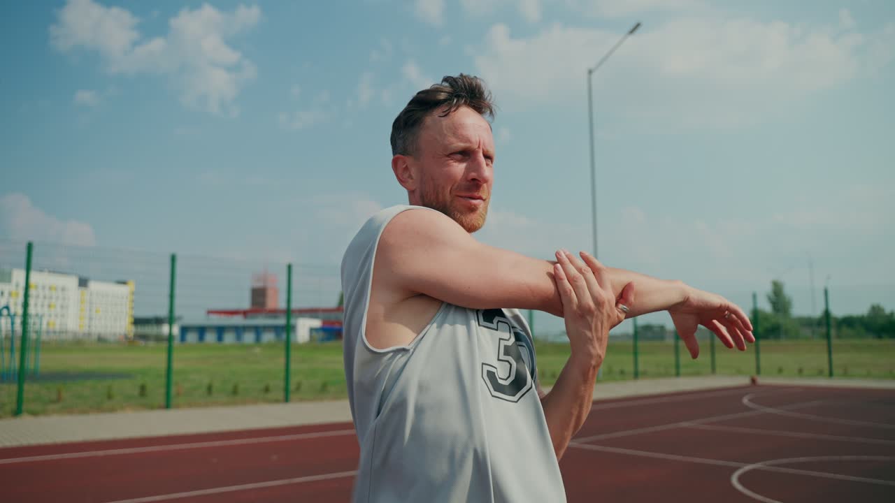 Uomo che fa stretching su un campo da basket