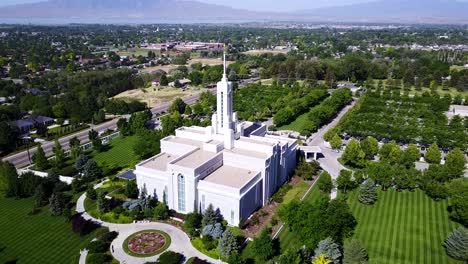 drone shot flying away from the mount timpanogos temple. the temple is owned and operated by the church of jesus christ of latter day saints.