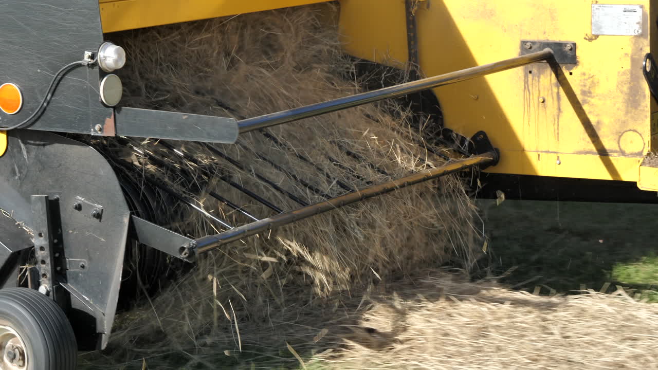 Slomo shot of hay machine in field