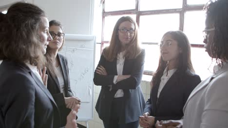 Happy-businesswomen-chatting-in-office