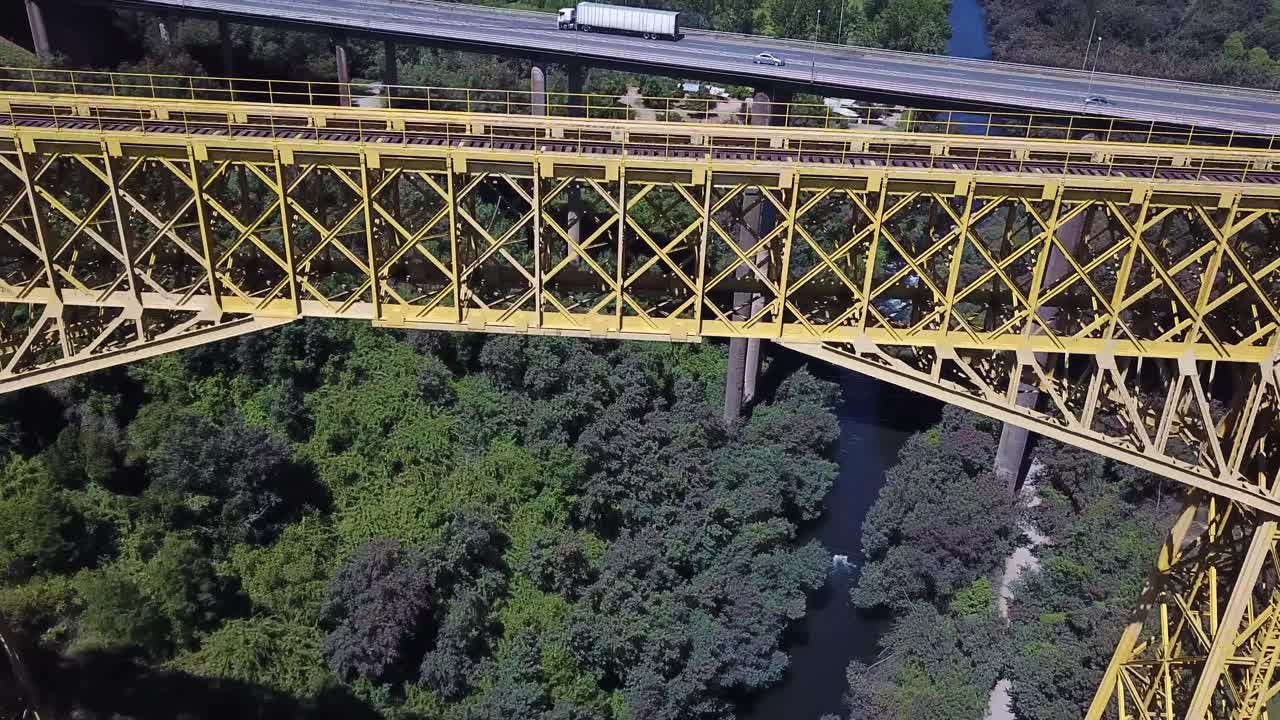 Malleco Viaduct. Chile. Tilt Up Aerial View of Old Railway Monument Bridge and Panamericana Highway on Sunny Day