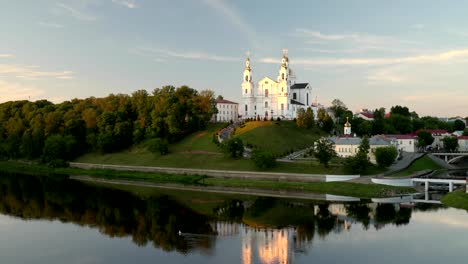 vitebsk, belarus. assumption cathedral church in upper town on uspensky mount hill and dvina river in summer evening sunset time. zoom, zoom in