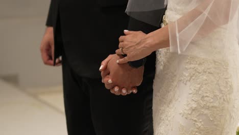 bride and groom holding hands in front of the altar in the church during their wedding day