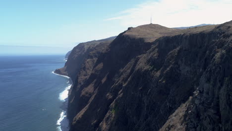 Madeira-Madeira-Ponto-da-Pargo-Lighthouse-aerial-tracking-shot-from-sea-to-land