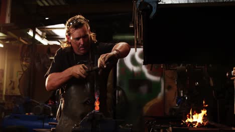 Blacksmith-working-at-workshop