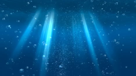 underwater light rays and bubbles in deep blue water