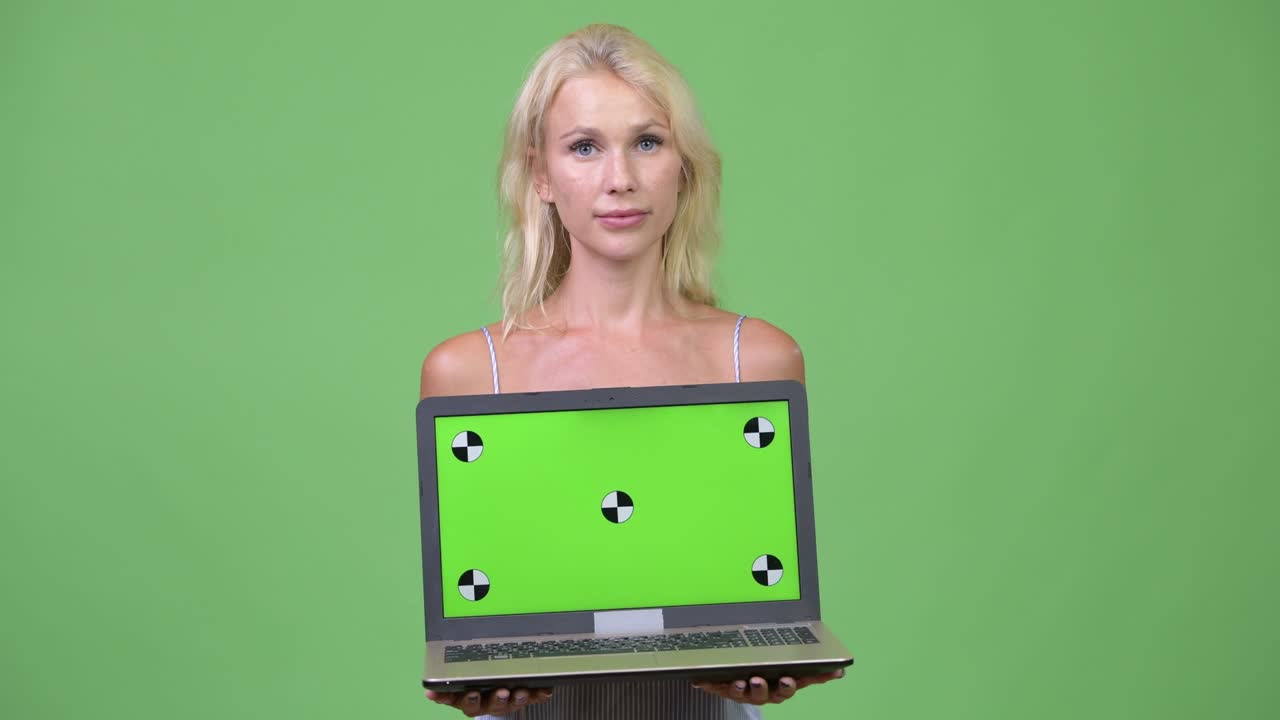 Young happy beautiful businesswoman showing laptop