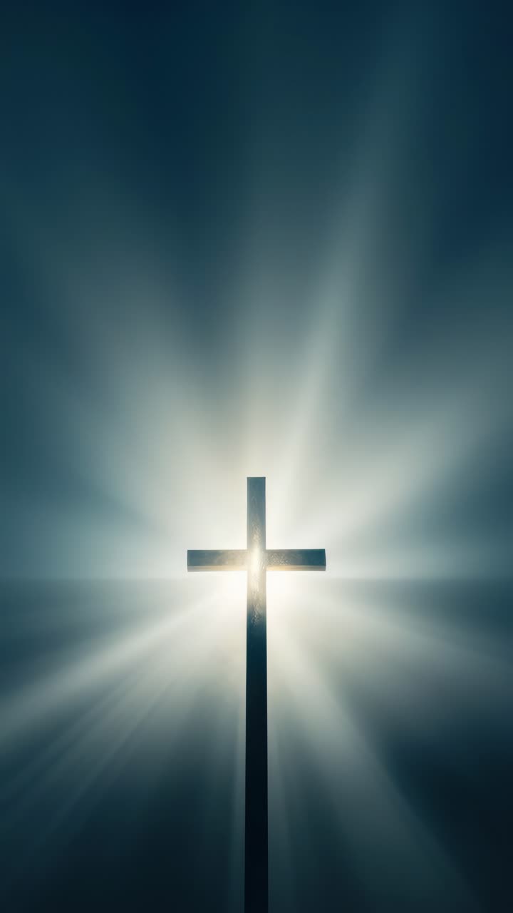 A dramatic, low-angle shot of a cross with radiant light beams, creating a spiritual and uplifting