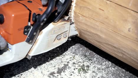 chainsaw cutting a log