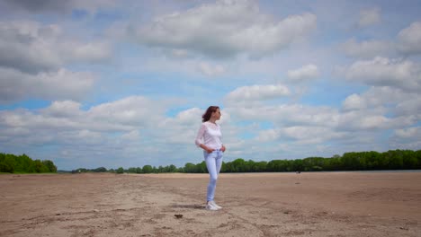 pretty woman in white dress enjoying trip on sandy beach