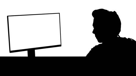 silhouette professional gamer looking at his personal computer