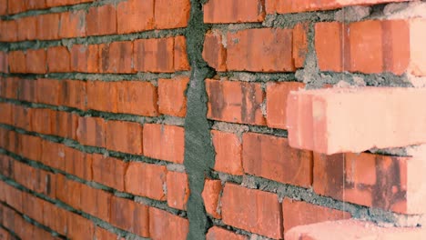 asian man covering electrical conduit using mortar