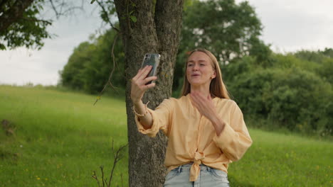 woman, mobile phone, video call, saying hi