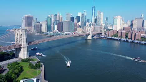 drone aerial landscape of cars driving over brooklyn bridge cityscape towers buildings skyscrapers of manhattan new york city usa america wall street east river travel transport