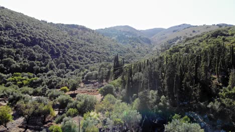 dense mountains revealed historical ruins in the mediterranean shore of agia sofia beach in kefalonia island, greece. aerial tilt-up