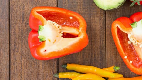 Animation-of-close-up-of-vegetables-on-wooden-background