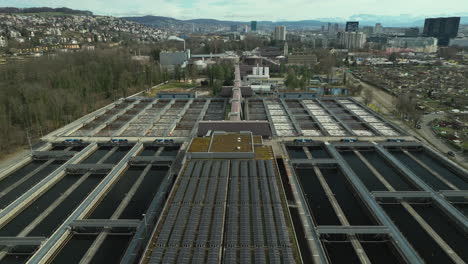 Roof-top-covered-by-solar-panels-on-a-water-treatment-plant-in-Zurich-on-a-cloudy-day