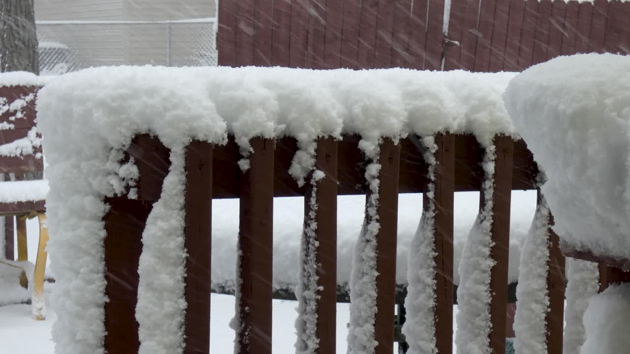 Heavy snow piles up on porch railings