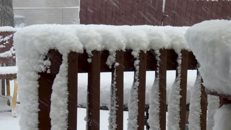 heavy snow piles up on porch railings