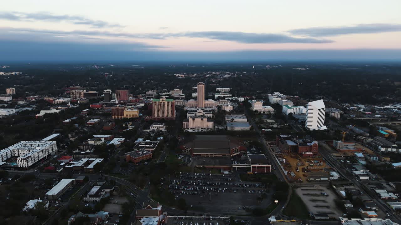 Establishing drone shot around the skyline of Tallahassee, dusk in Florida, USA