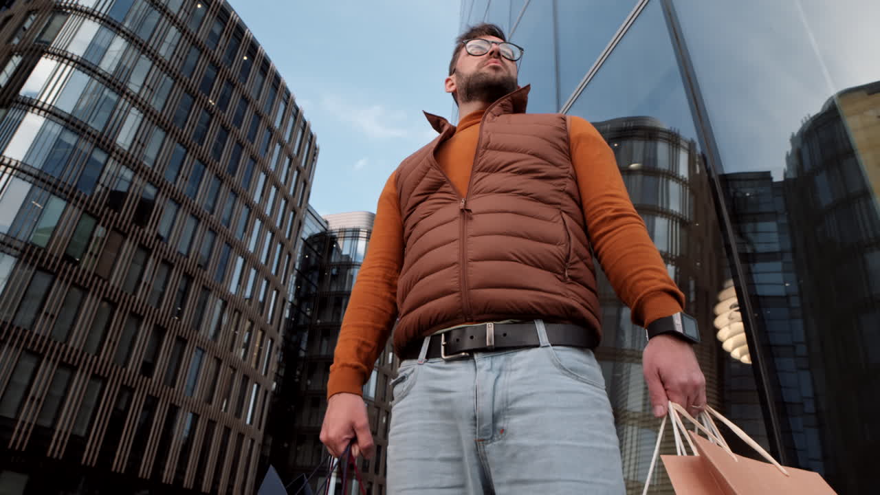 Man Holding Shopping Bags in City
