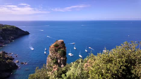 boats crossing a cove at praiano, italy as seen from a scenic overlook in daytime in spring - panoramic time lapse