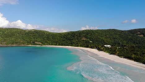 stunning secluded beack in forest covered mountains with crystal clear blue sea