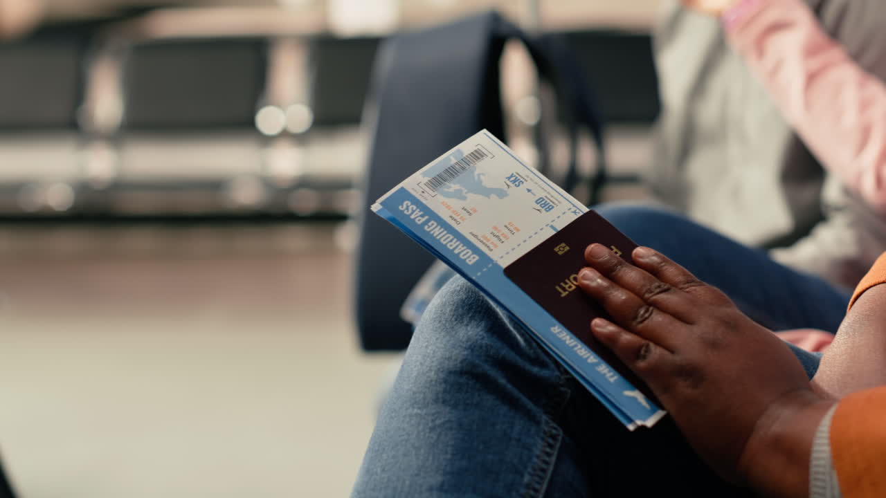 Plane ticket and passport, close up, flight details in airport, departure area