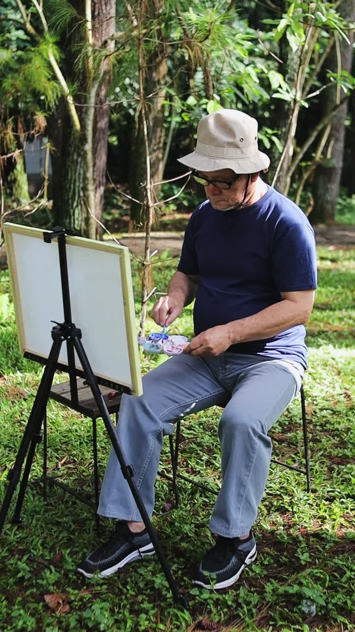 Elderly artist captures nature's beauty painting outdoors with canvas in a serene forest setting