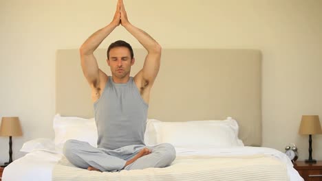 Man-doing-yoga-on-the-bed