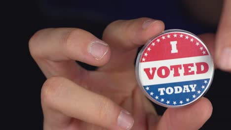 4k resolution closeup video of a hand holding i voted today button. elections concept