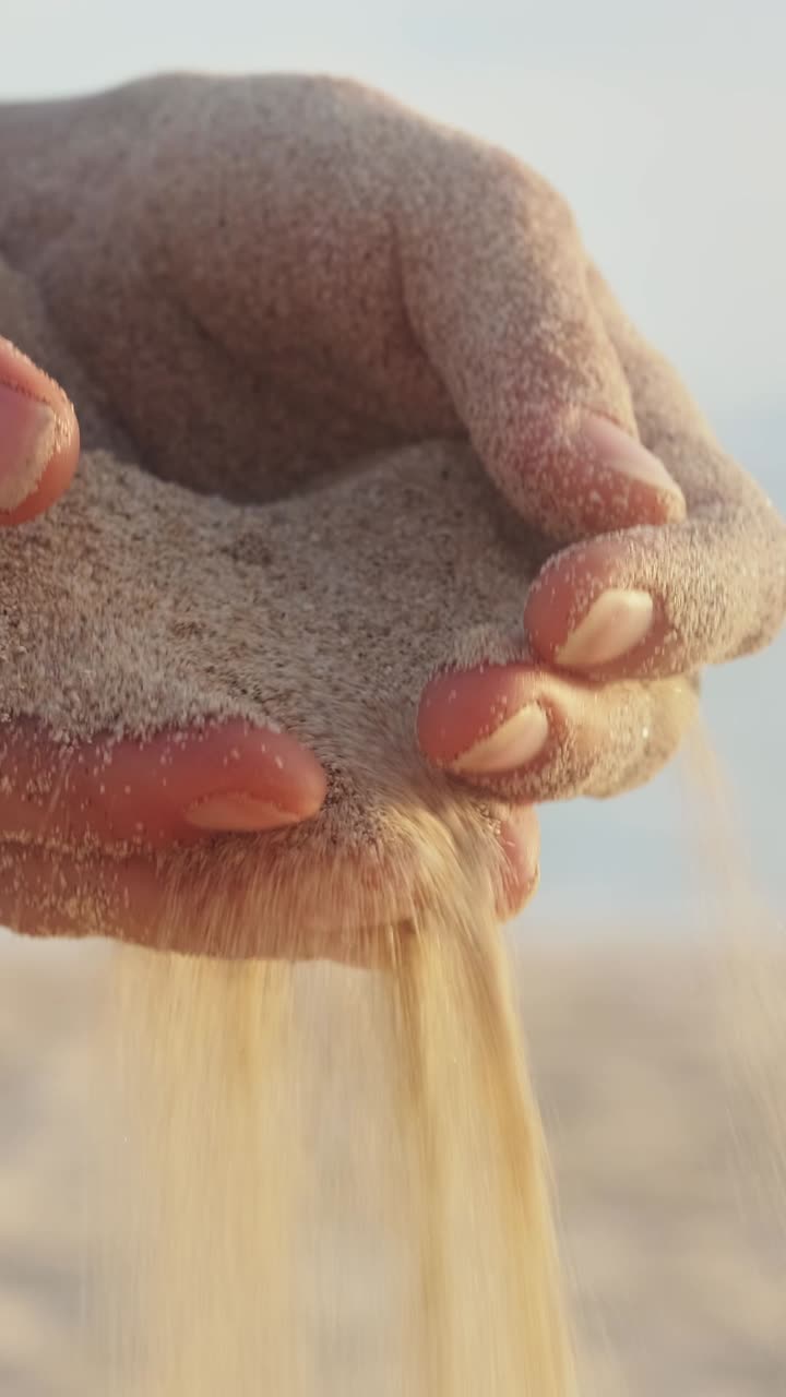 Holding the warmth of sand a moment of serenity by the shore